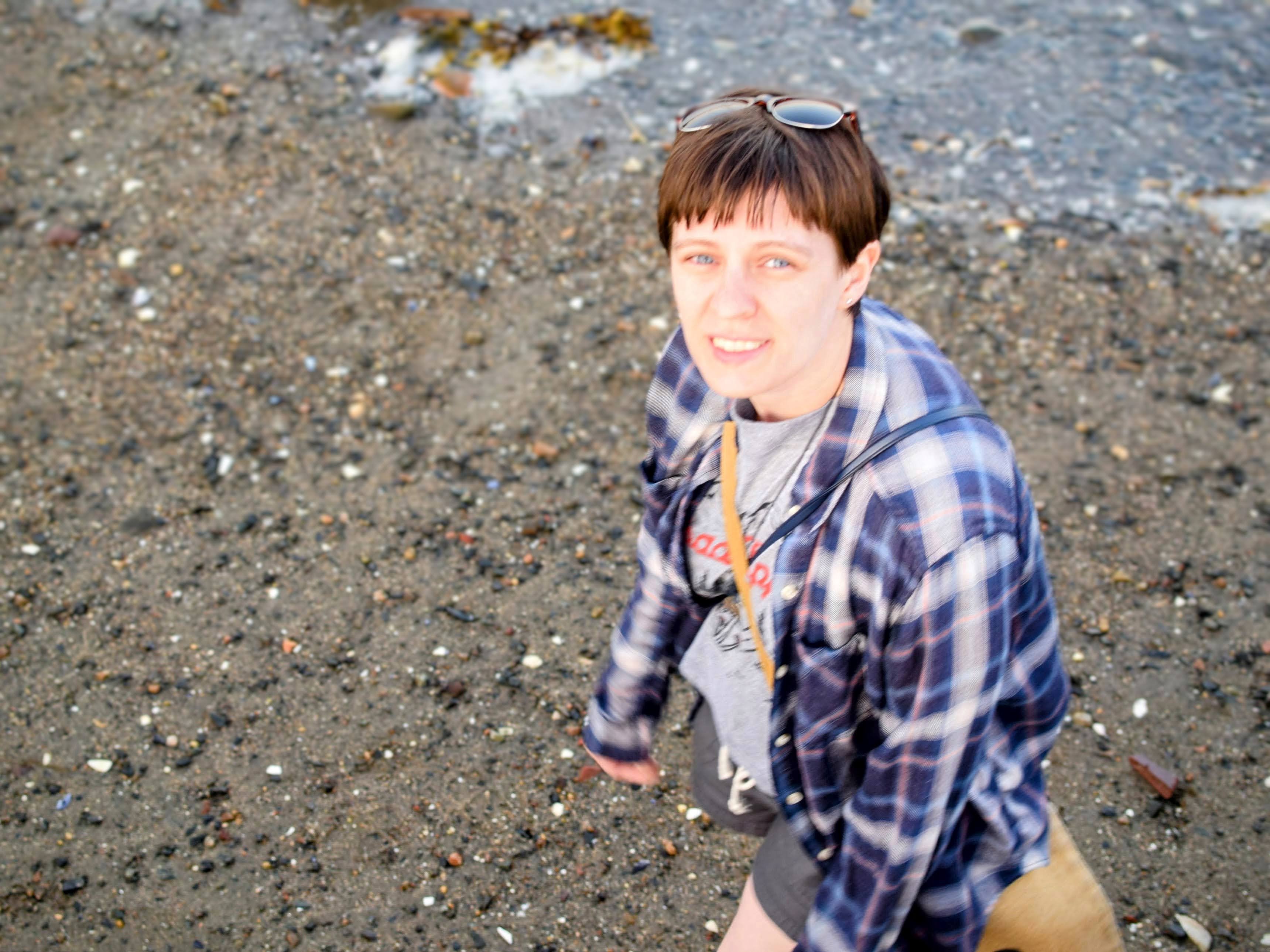 Amber looking up me, the beach behind them