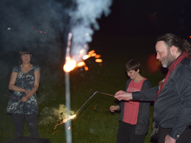 Kristina, Amber, and Daniel playing with sparklers in the dark