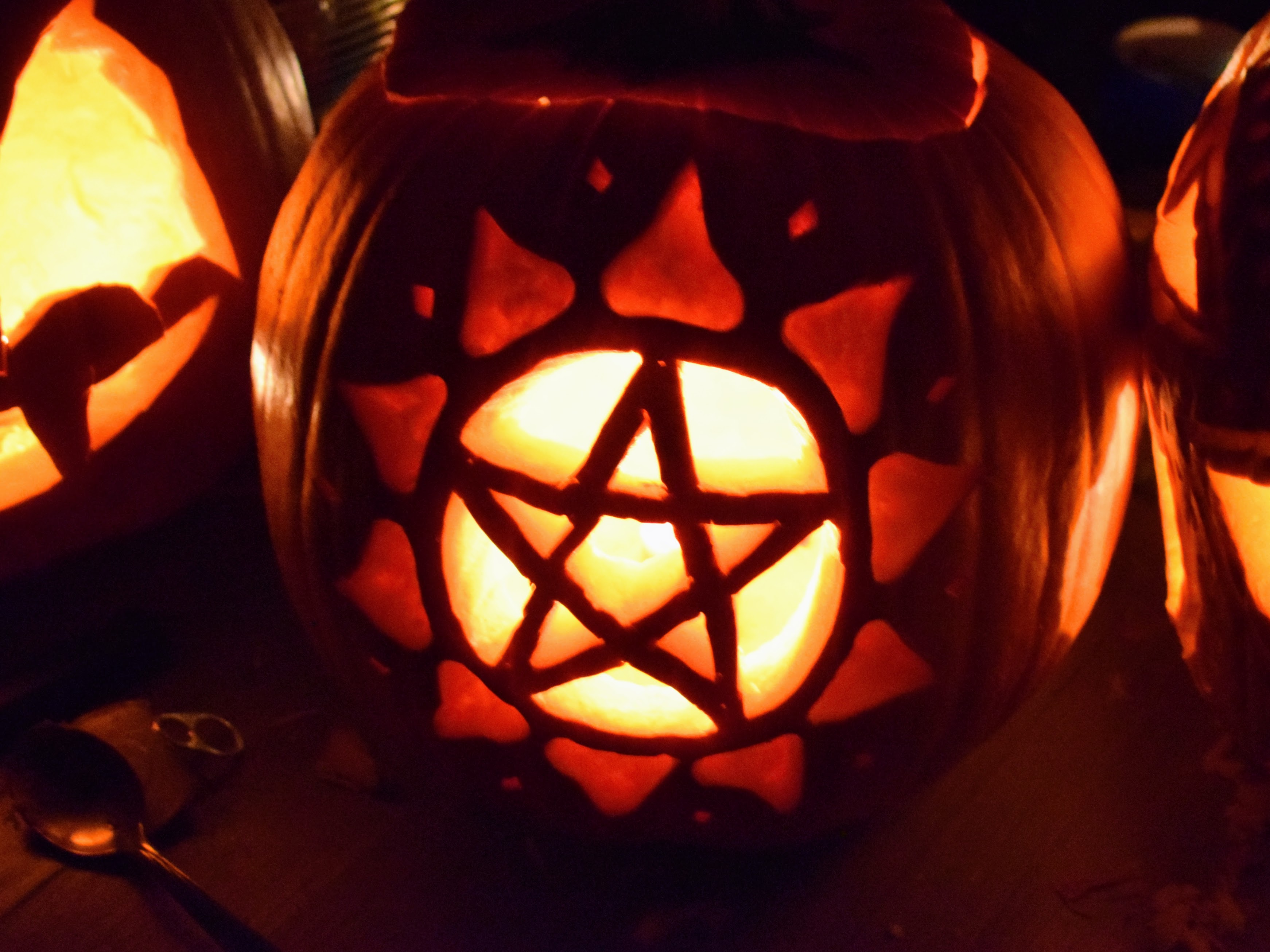 A pentacle carved into a pumpkin