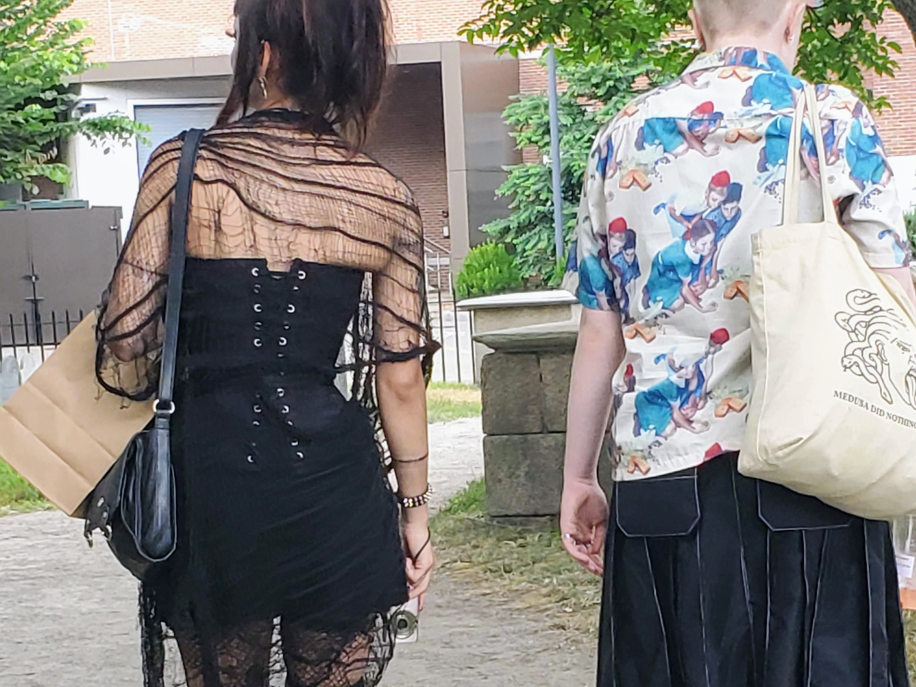 A goth dressed woman in a thin shawl and a corset