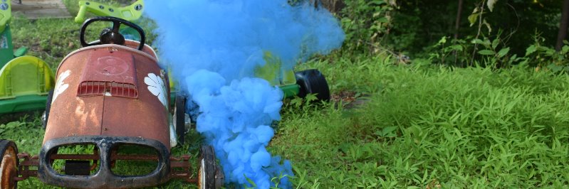 Blue smoke next to a rusty cart