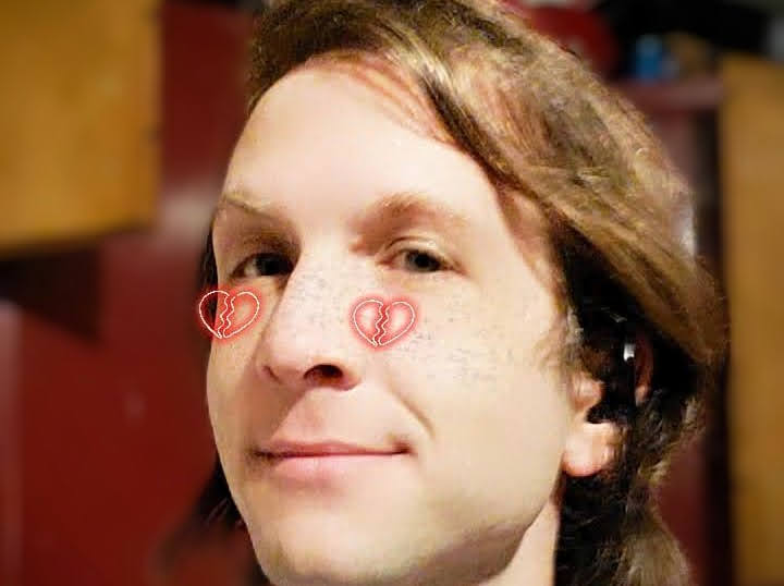 Close up of man with hearts on his face