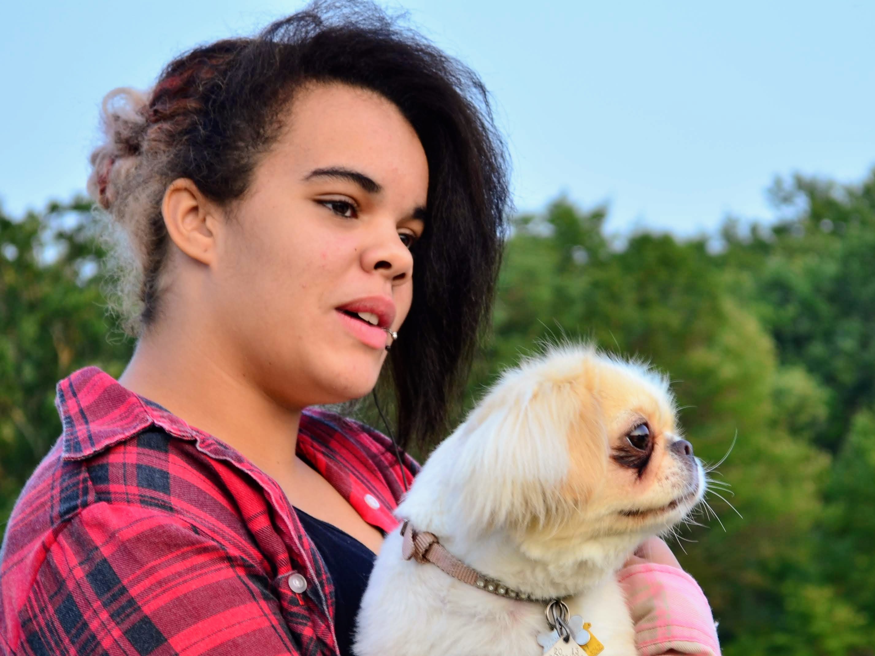 Ayannah holding a white dog